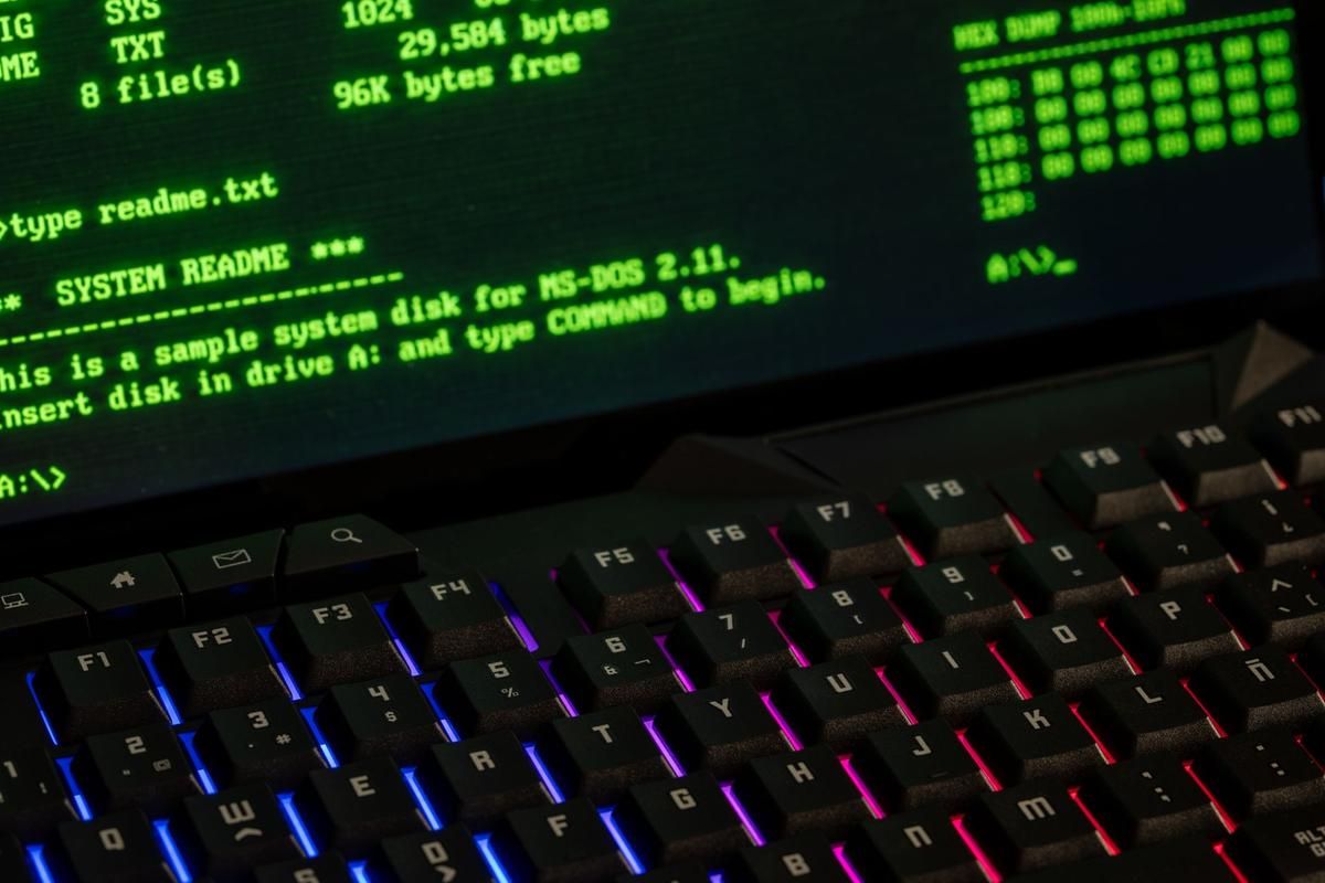 Écran affichant du code système et clavier gaming rétroéclairé en couleurs vives Écran affichant du code système et clavier gaming rétroéclairé en couleurs vives